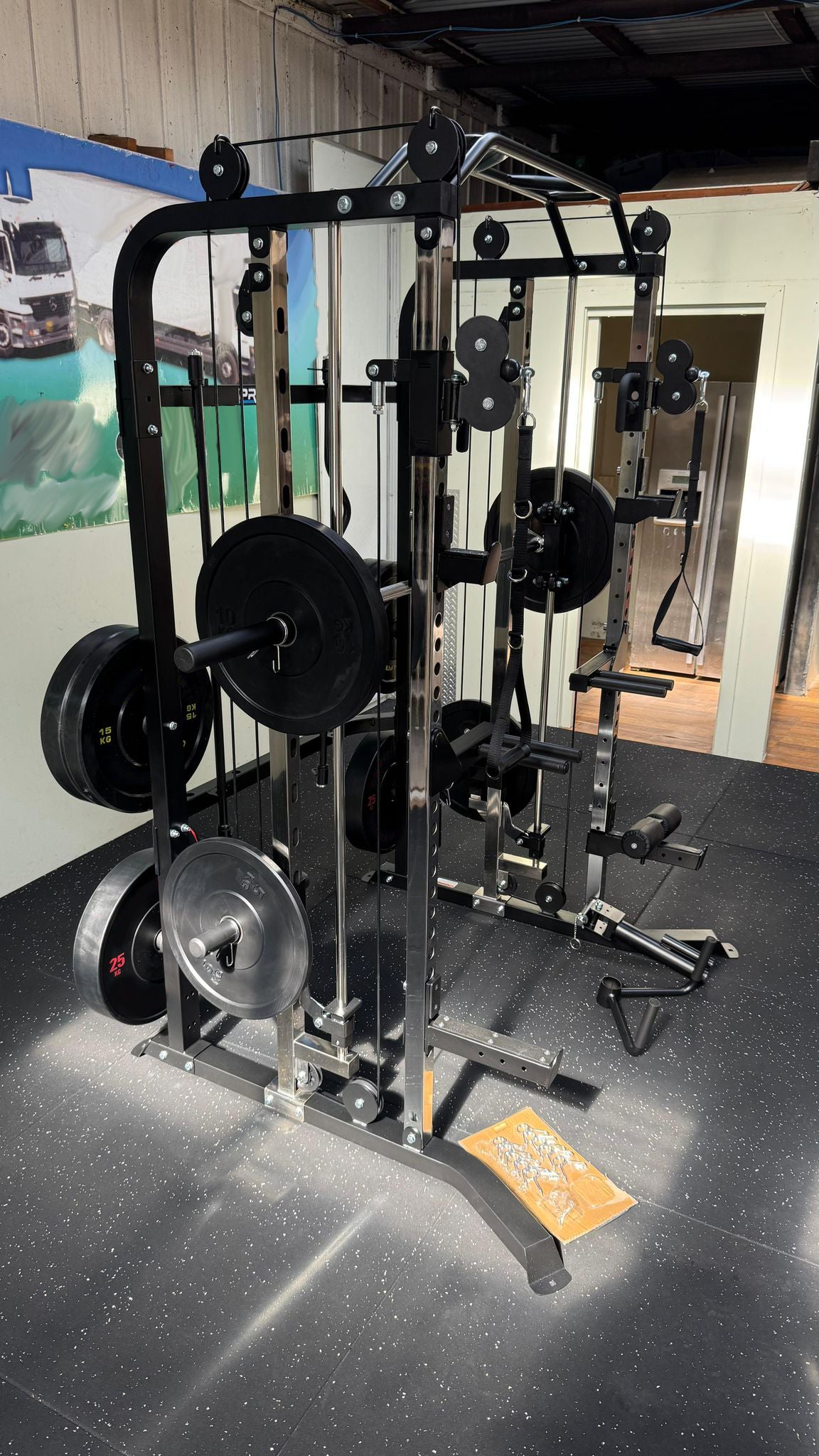 Second client-assembled G3S functional smith machine installed in a home gym with bench, plates and dumbbells